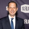 Daniel Lurie looks straight ahead and smiles as he poses for a photo at a film festival.