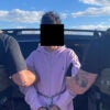 Two ICE agents, their backs turned toward the camera, hold a 16-year-old illegal immigrant in light purple hoodie. The teen's face is blacked out.