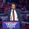 Turning Point USA President Charlie Kirk gestures