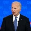 Joe Biden stands with a confused look on his face and he looks to his left during a debate.
