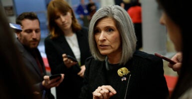 Joni Ernst in black gestures