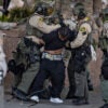 a demonstrator surrounded and arrested by LA Sheriff's deputies